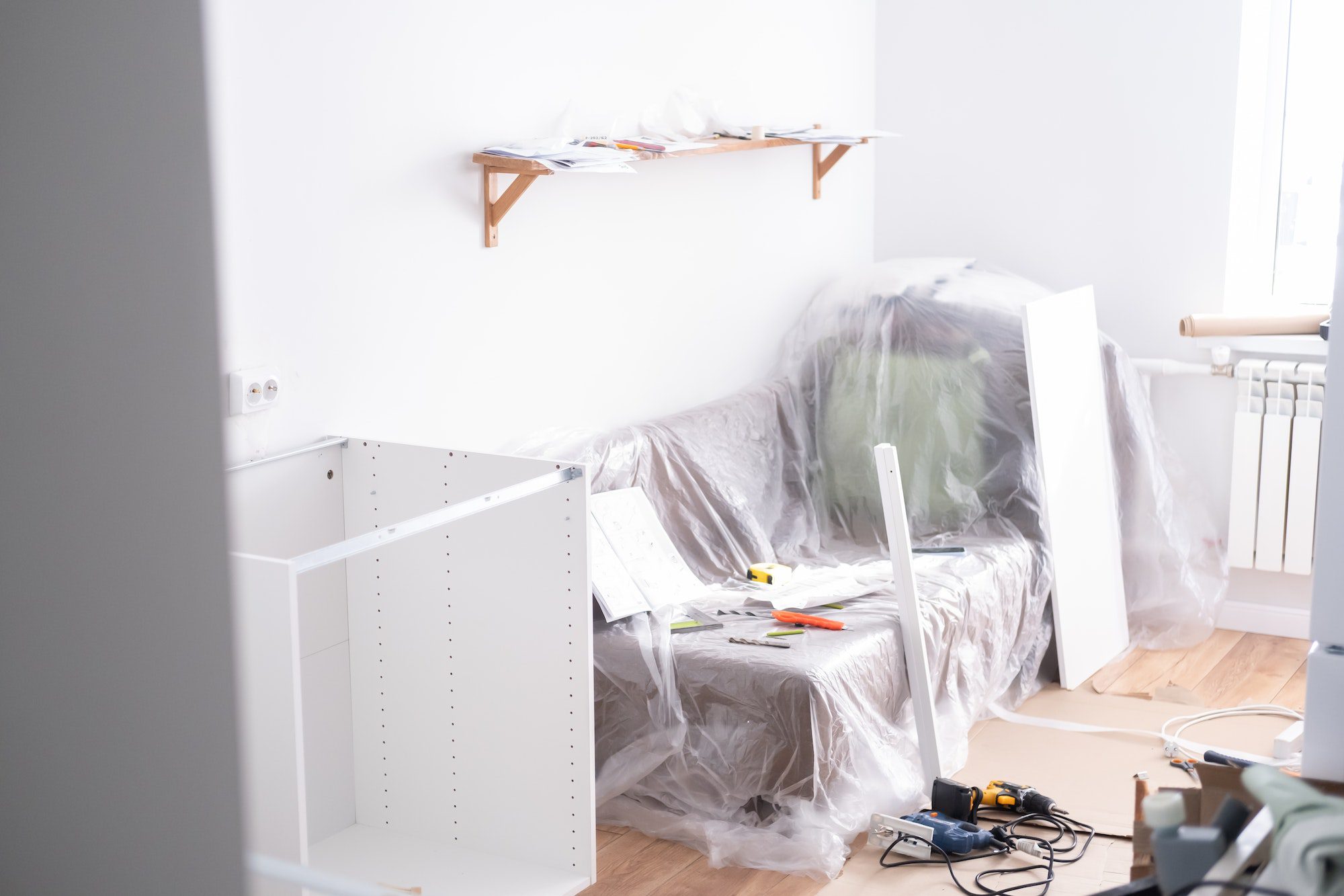 Assembling the white frames of the modular kitchen. Step by step assembly process for a modular